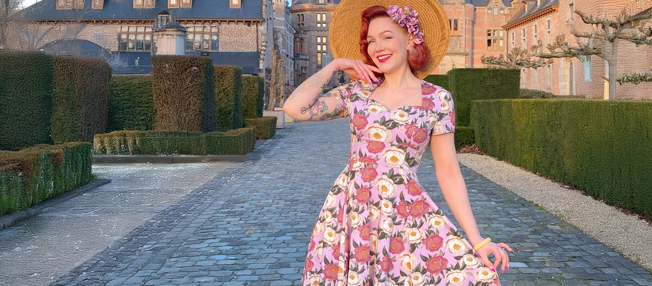 Woman wearing a floral A-line dress and a hat